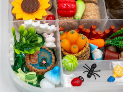 Deluxe Gardening Play-Doh Kit with colorful dough and miniature vegetables, flowers, plants, garden accessories, basket, and nature-themed pieces
