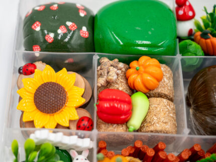 Deluxe Gardening Play-Doh Kit with colorful dough and miniature vegetables, flowers, plants, garden accessories, basket, and nature-themed pieces