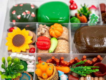 Deluxe Gardening Play-Doh Kit with colorful dough and miniature vegetables, flowers, plants, garden accessories, basket, and nature-themed pieces