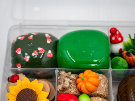 Deluxe Gardening Play-Doh Kit with colorful dough and miniature vegetables, flowers, plants, garden accessories, basket, and nature-themed pieces