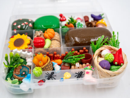 Deluxe Gardening Play-Doh Kit with colorful dough and miniature vegetables, flowers, plants, garden accessories, basket, and nature-themed pieces