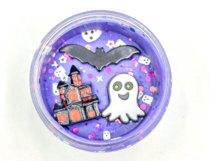 Four Halloween playdough jars with glitter and ghost, bat, cauldron, and haunted house charms