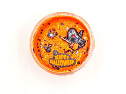 Four Halloween playdough jars with glitter and ghost, bat, cauldron, and haunted house charms