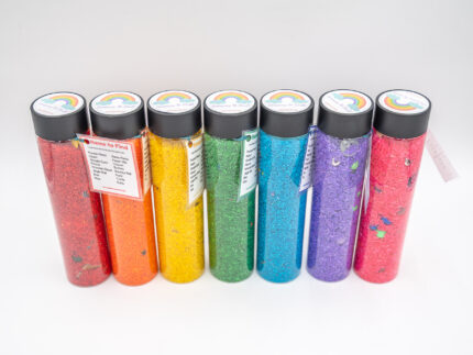 I Spy Bottles filled with rainbow colored rice and hidden items, with laminated word lists and picture cards
