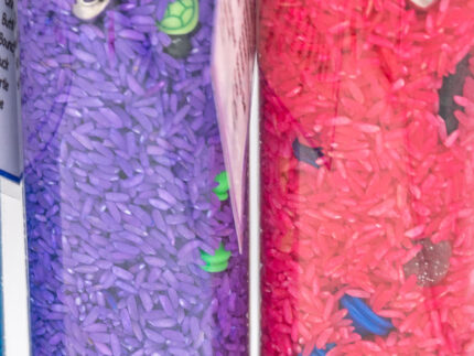 I Spy Bottles filled with rainbow colored rice and hidden items, with laminated word lists and picture cards