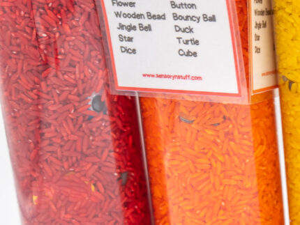 I Spy Bottles filled with rainbow colored rice and hidden items, with laminated word lists and picture cards