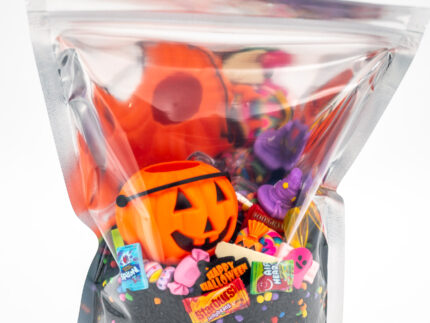 Trick-or-Treat Budget Bag with black rice, rainbow couscous, jack-o'-lantern container, pretend candy, Halloween charms, and ghost eraser