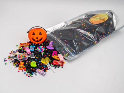 Trick-or-Treat Budget Bag with black rice, rainbow couscous, jack-o'-lantern container, pretend candy, Halloween charms, and ghost eraser