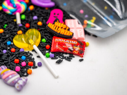 Trick-or-Treat Budget Bag with black rice, rainbow couscous, jack-o'-lantern container, pretend candy, Halloween charms, and ghost eraser