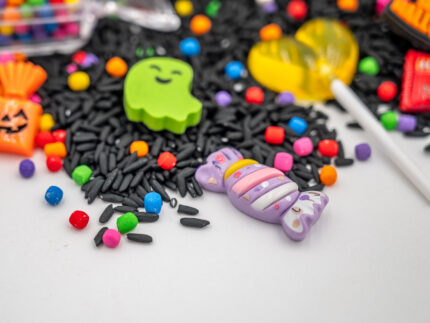 Trick-or-Treat Budget Bag with black rice, rainbow couscous, jack-o'-lantern container, pretend candy, Halloween charms, and ghost eraser