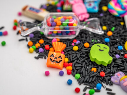 Trick-or-Treat Budget Bag with black rice, rainbow couscous, jack-o'-lantern container, pretend candy, Halloween charms, and ghost eraser
