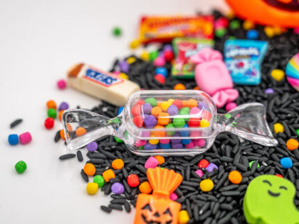 Trick-or-Treat Budget Bag with black rice, rainbow couscous, jack-o'-lantern container, pretend candy, Halloween charms, and ghost eraser