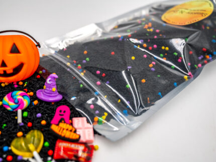 Trick-or-Treat Budget Bag with black rice, rainbow couscous, jack-o'-lantern container, pretend candy, Halloween charms, and ghost eraser